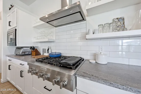 a kitchen with granite countertop a stove and a sink
