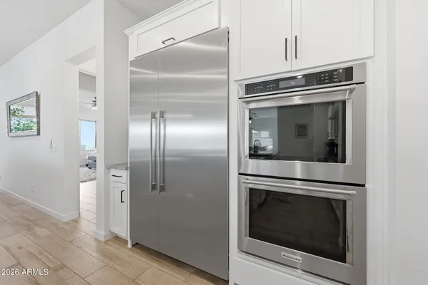 a kitchen with cabinets and stainless steel appliances
