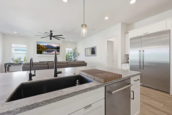 a kitchen with granite countertop a sink and a refrigerator