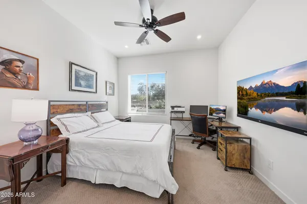 a bedroom with a bed gym equipment and a window