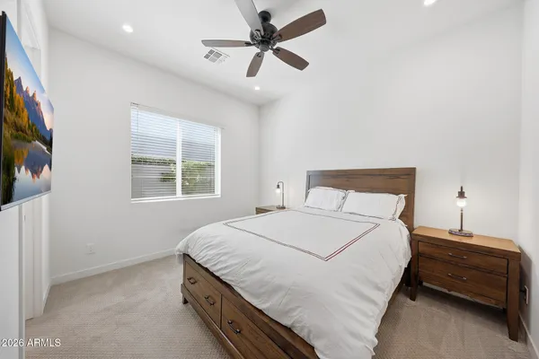 a bedroom with a bed and a chandelier