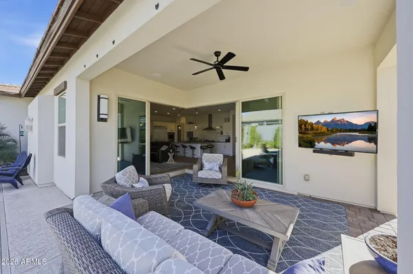 a view of a swimming pool with a yard and furniture