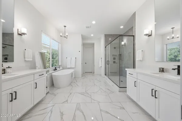 a large bathroom with a double vanity sink a large mirror and shower