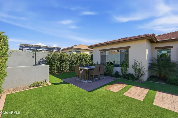 a view of a house with backyard sitting area and garden