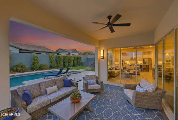 a view of a patio with swimming pool table and chairs