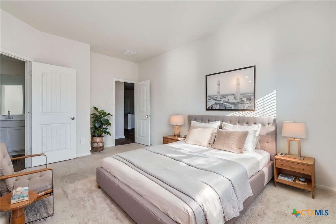 316 Addison Place Lockhart, TX 78644 - Photo 13 of 28 a bedroom with a bed and a painting on the wall