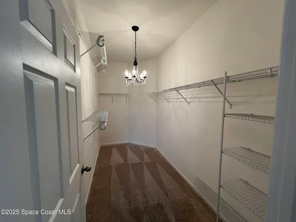 a view of a hallway with a chandelier