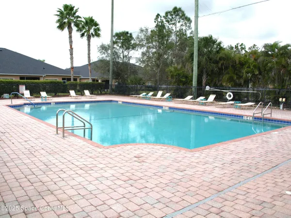 a view of a swimming pool with a patio