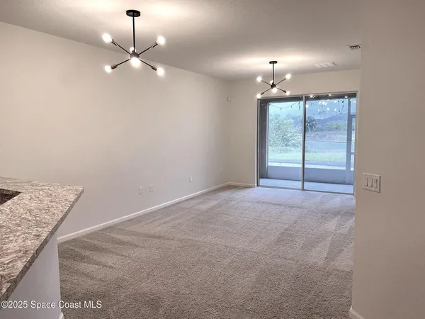 en empty room with windows and outdoor view