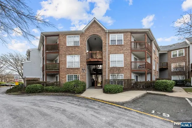 a front view of a building with a yard