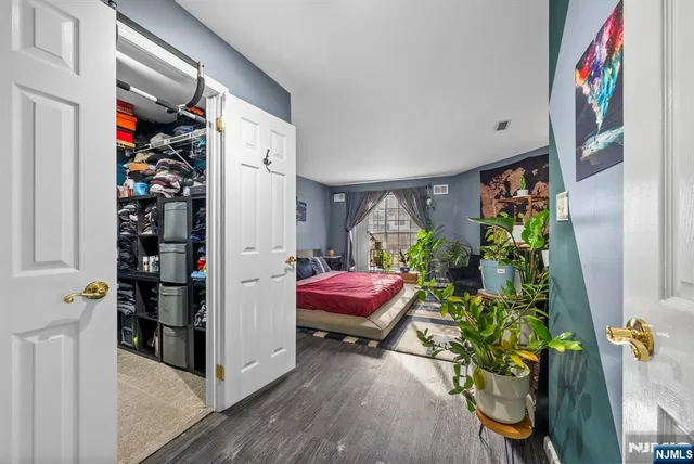 a bedroom with a bed dresser and window