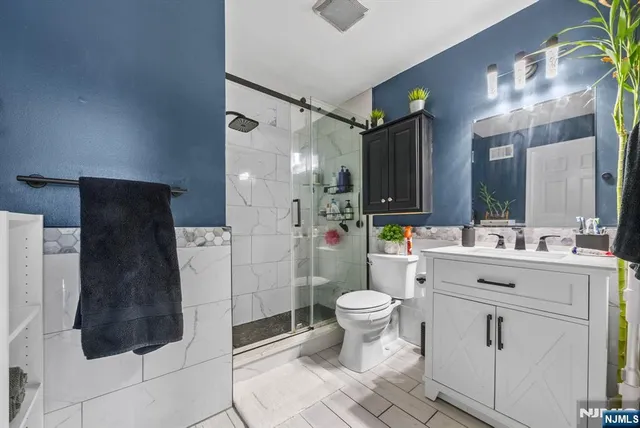 a white painted room with a potted plant