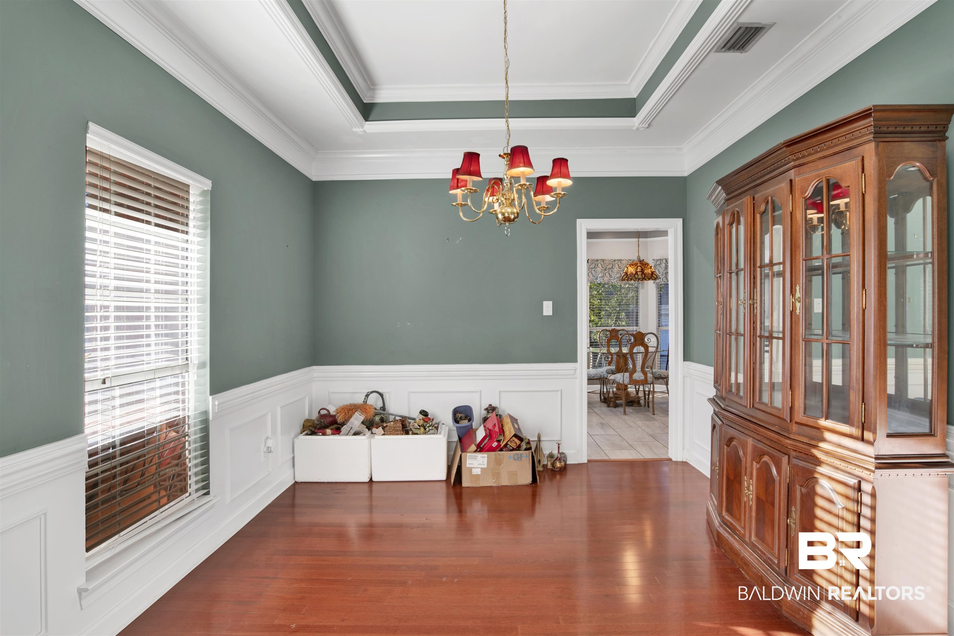 445 Wedgefield Drive South Mobile, AL 36608 - Photo 10 of 36 Dining area featuring hardwood / wood-style floors, ornamental molding, and an inviting chandelier