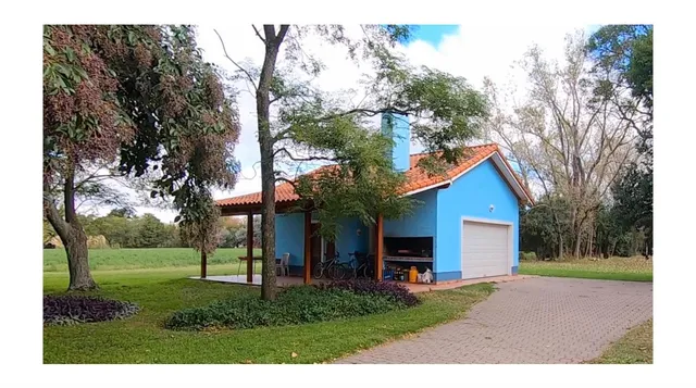 a porch with a table chairs and a yard