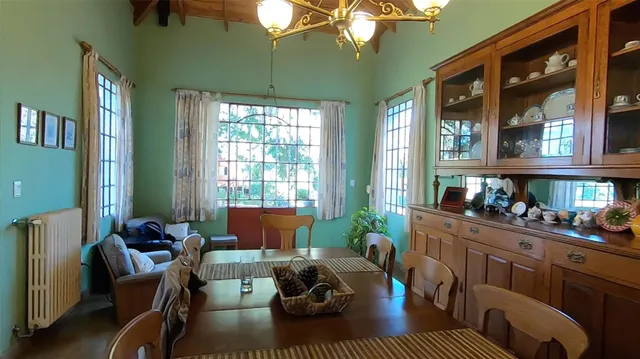 a dining room with furniture and a large window
