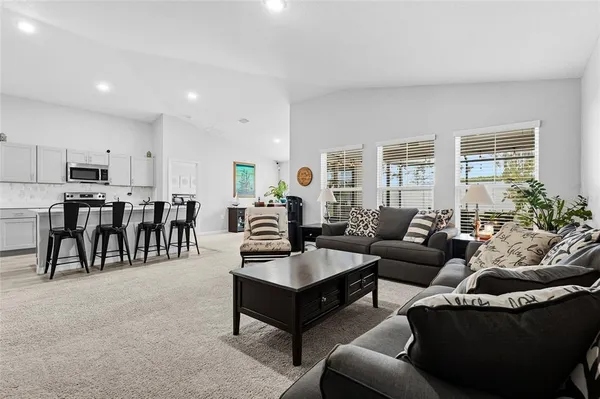 a view of a dining room with furniture and chandelier