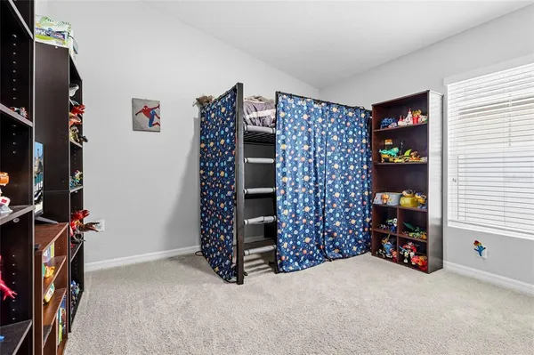 an entryway with a cabinet and a flat screen tv