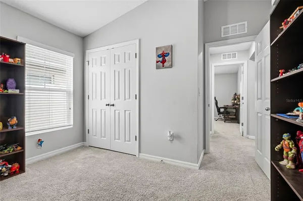 a room with lots of books and furniture