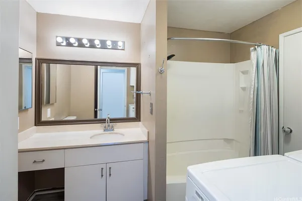 a bathroom with a sink a mirror and a shower