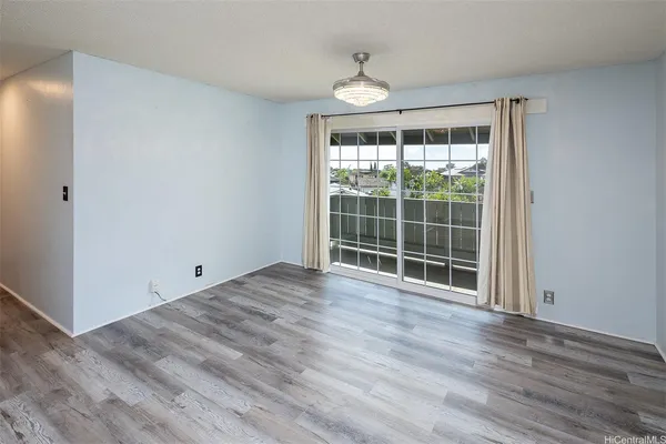 a view of a room with wooden floor and windows