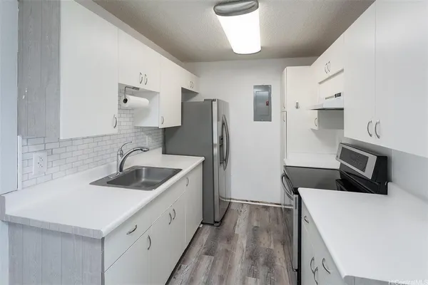 a kitchen that has a sink and a stove top oven