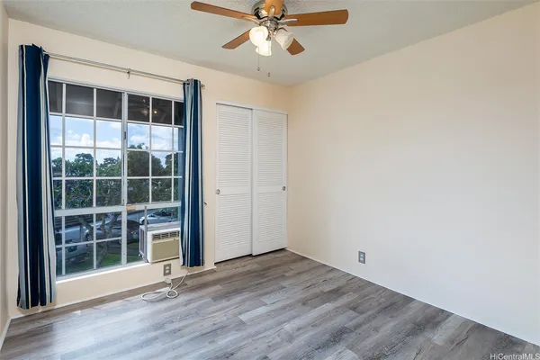 an empty room with wooden floor and door