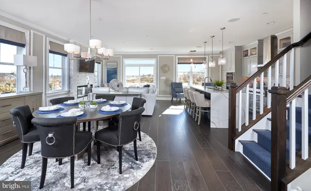 a kitchen with wooden floors and white cabinets