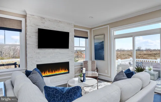 a view of a dining room and livingroom with lots of furniture wooden floor and a chandelier