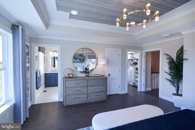 a bed sitting in a spacious bedroom next to a window