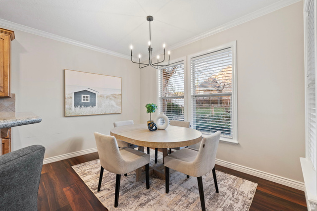 6208 West Bull River Road Highland, UT 84003 - Photo 28 of 90 Dining area featuring rich wood-finish flooring, white baseboards, and crown molding