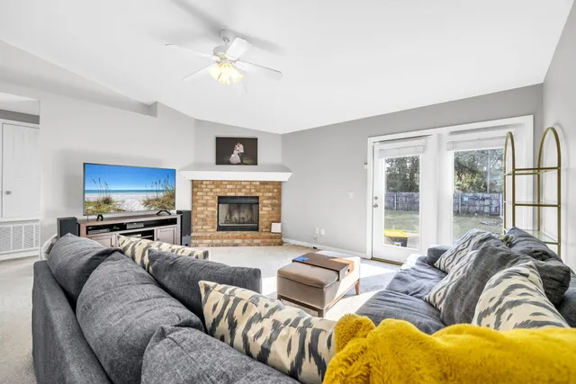 a living room with furniture fireplace and a flat screen tv