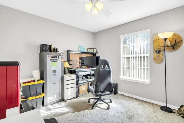 a view of a workspace with furniture and a window