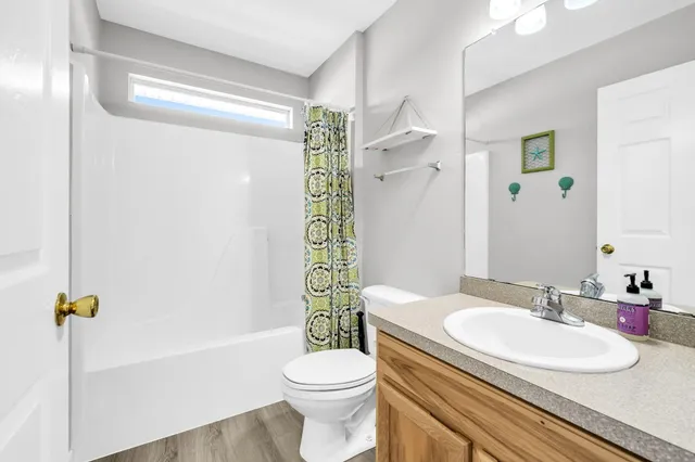 a bathroom with a sink toilet and shower