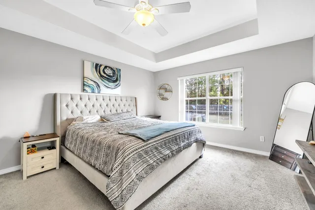 a spacious bedroom with a bed and a window