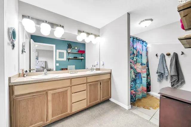 a bathroom with a sink vanity and mirror