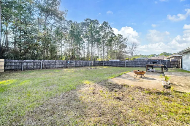 a view of a swimming pool with a yard