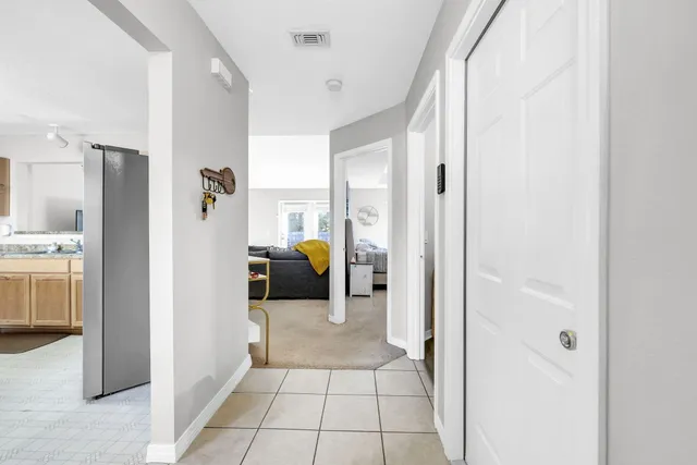 a view of a hallway with a livingroom and a livingroom