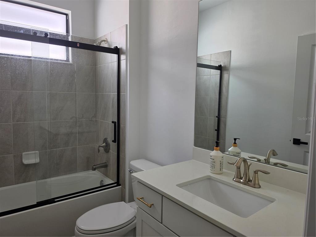 18334 Ridgeline Drive Estero, FL 33928 - Photo 15 of 30 a bathroom with a sink toilet and shower