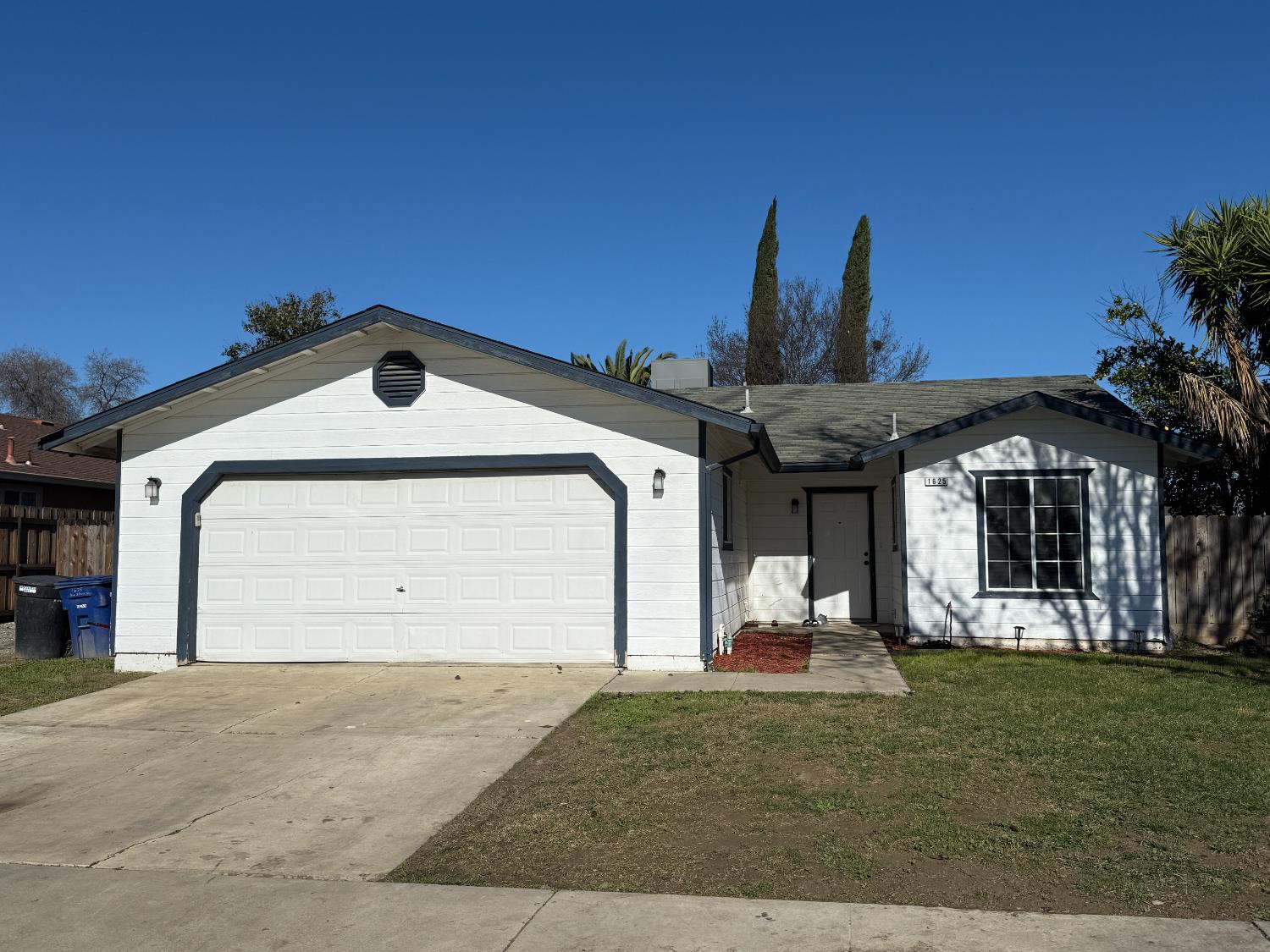 single story home featuring driveway and an attached garage
