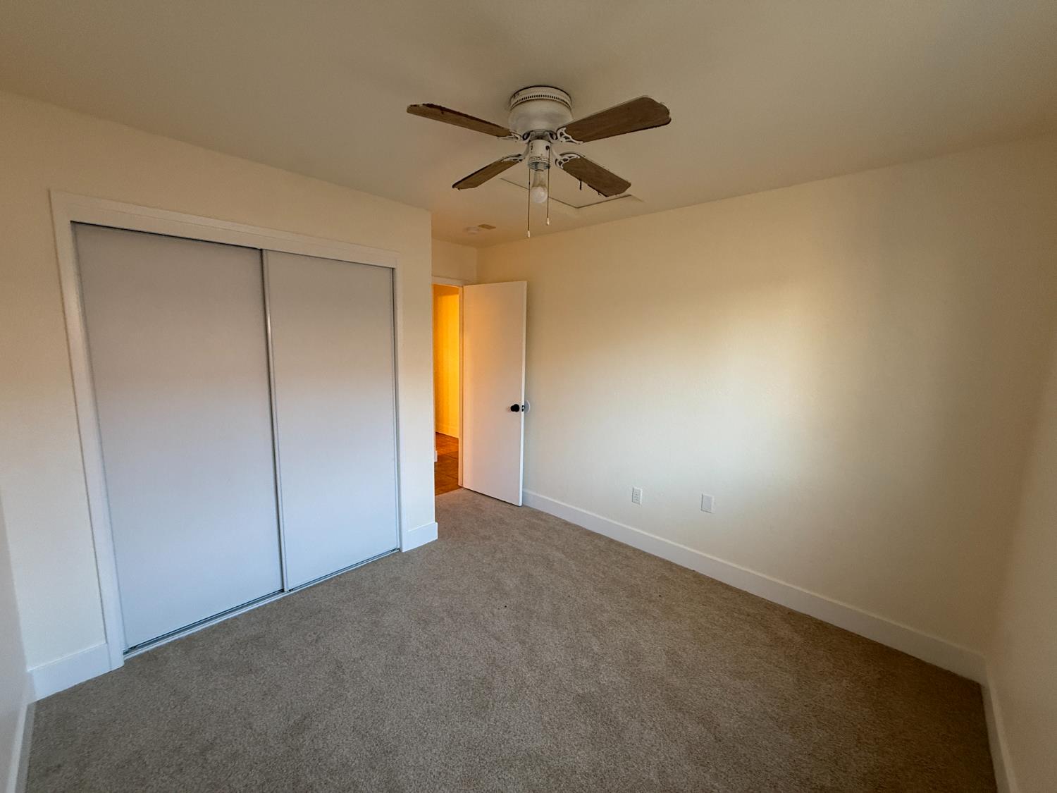 1625 Blue Spruce Way Newman, CA 95360 - Photo 17 of 22 unfurnished bedroom with carpet flooring, a closet, and ceiling fan