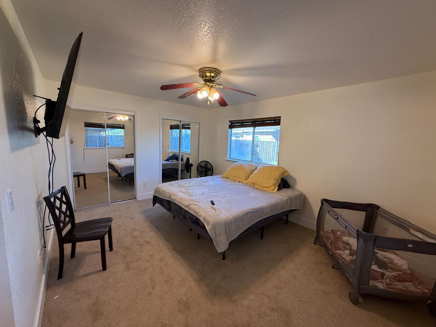 1625 Blue Spruce Way Newman, CA 95360 - Photo 20 of 22 bedroom with two closets, light colored carpet, a textured ceiling, and ceiling fan