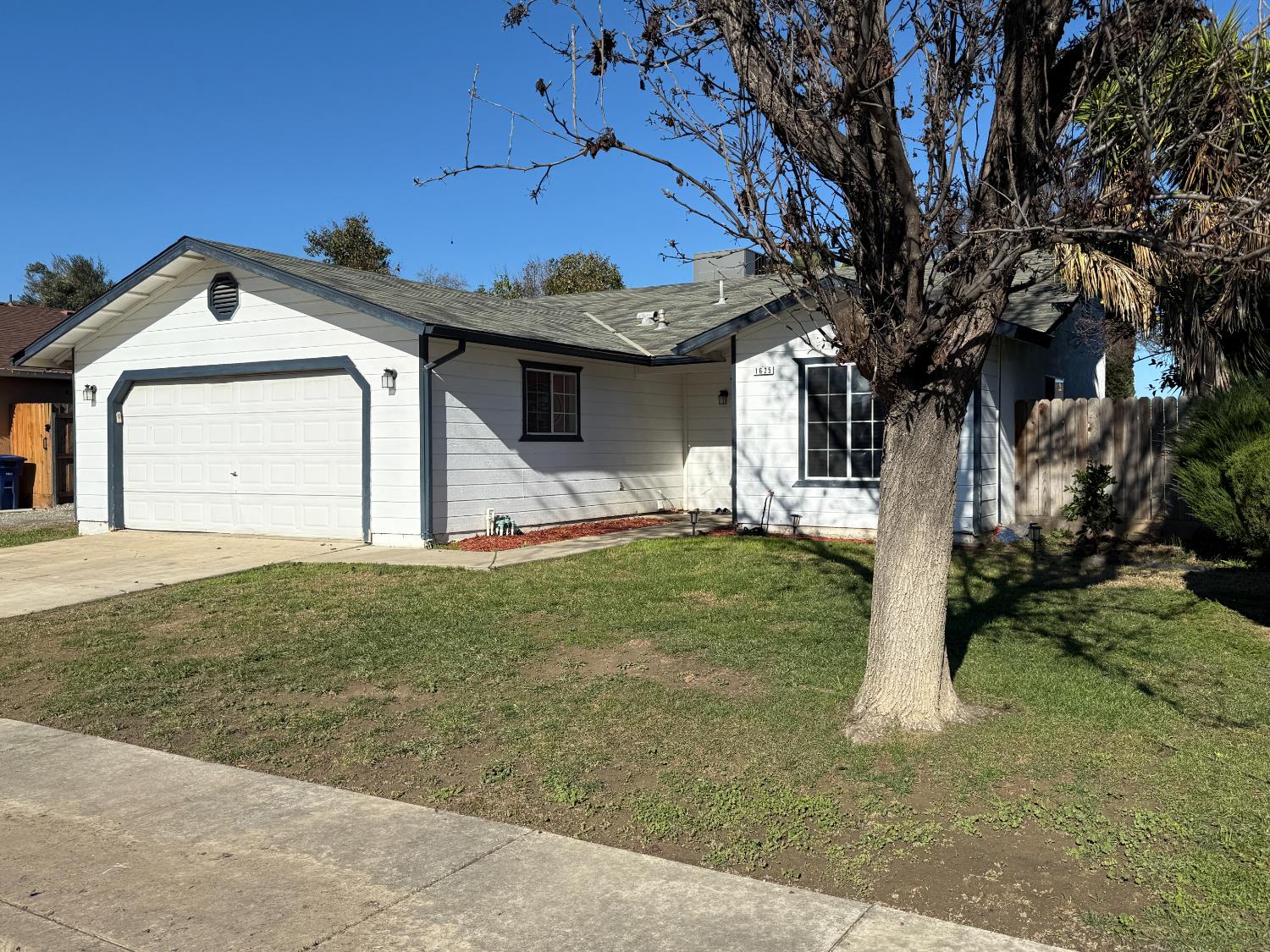 1625 Blue Spruce Way Newman, CA 95360 - Photo 2 of 22 single story home with concrete driveway, an attached garage, and roof with shingles