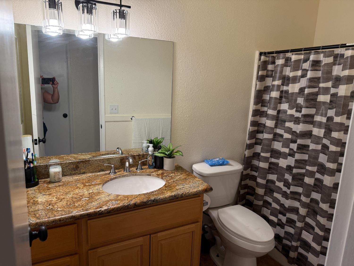 1625 Blue Spruce Way Newman, CA 95360 - Photo 22 of 22 bathroom featuring a textured wall, vanity, and a shower with curtain