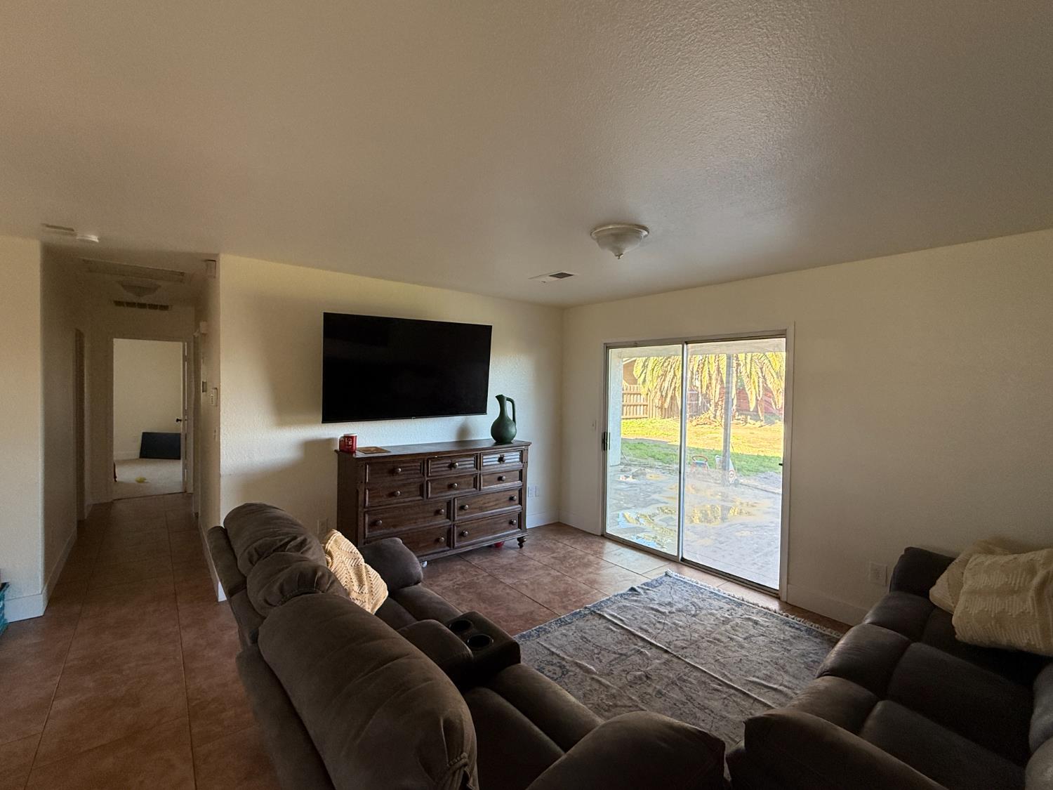 1625 Blue Spruce Way Newman, CA 95360 - Photo 8 of 22 living area with a textured ceiling and tile patterned floors