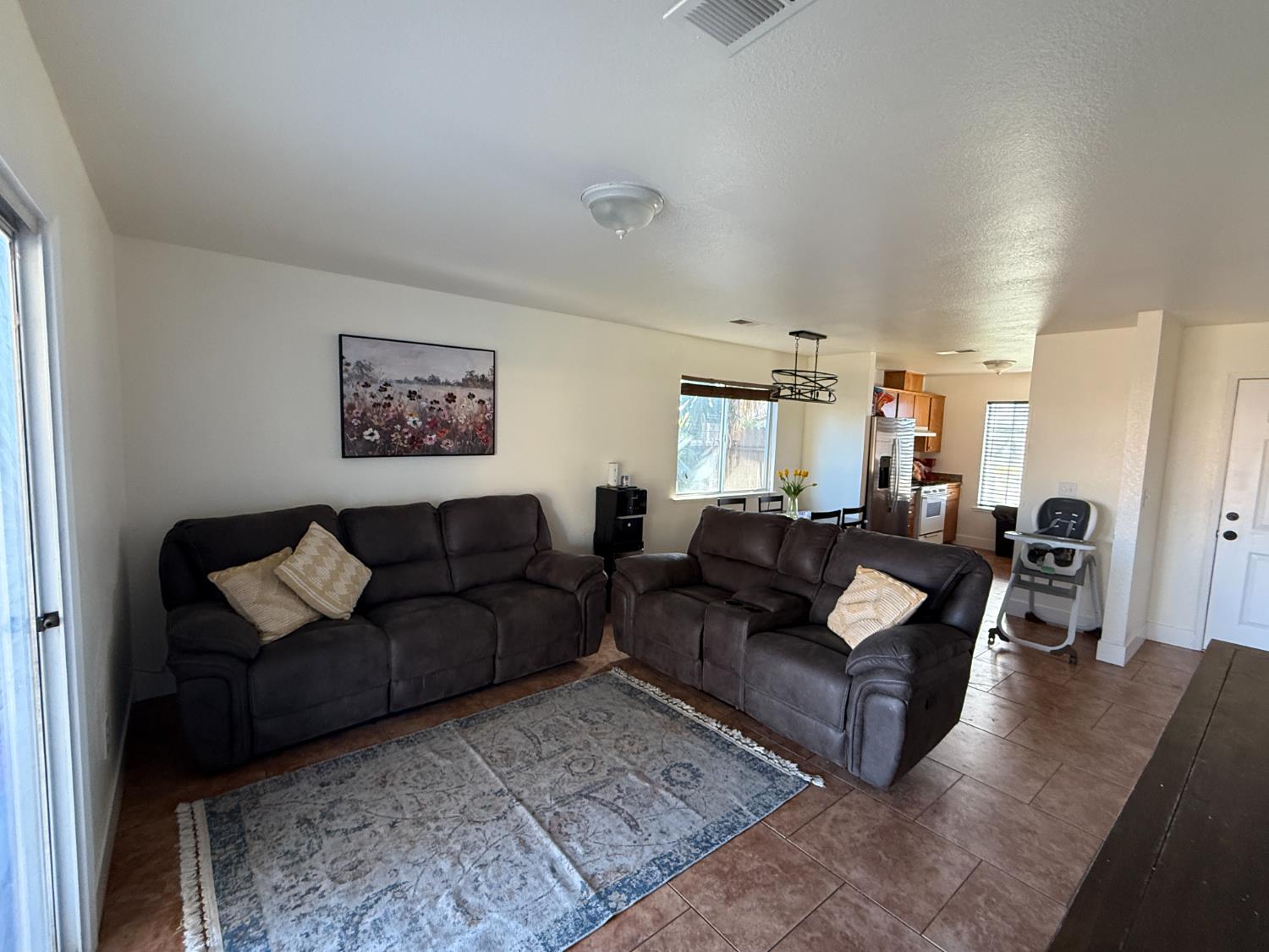 1625 Blue Spruce Way Newman, CA 95360 - Photo 10 of 22 living area with tile patterned floors and baseboards