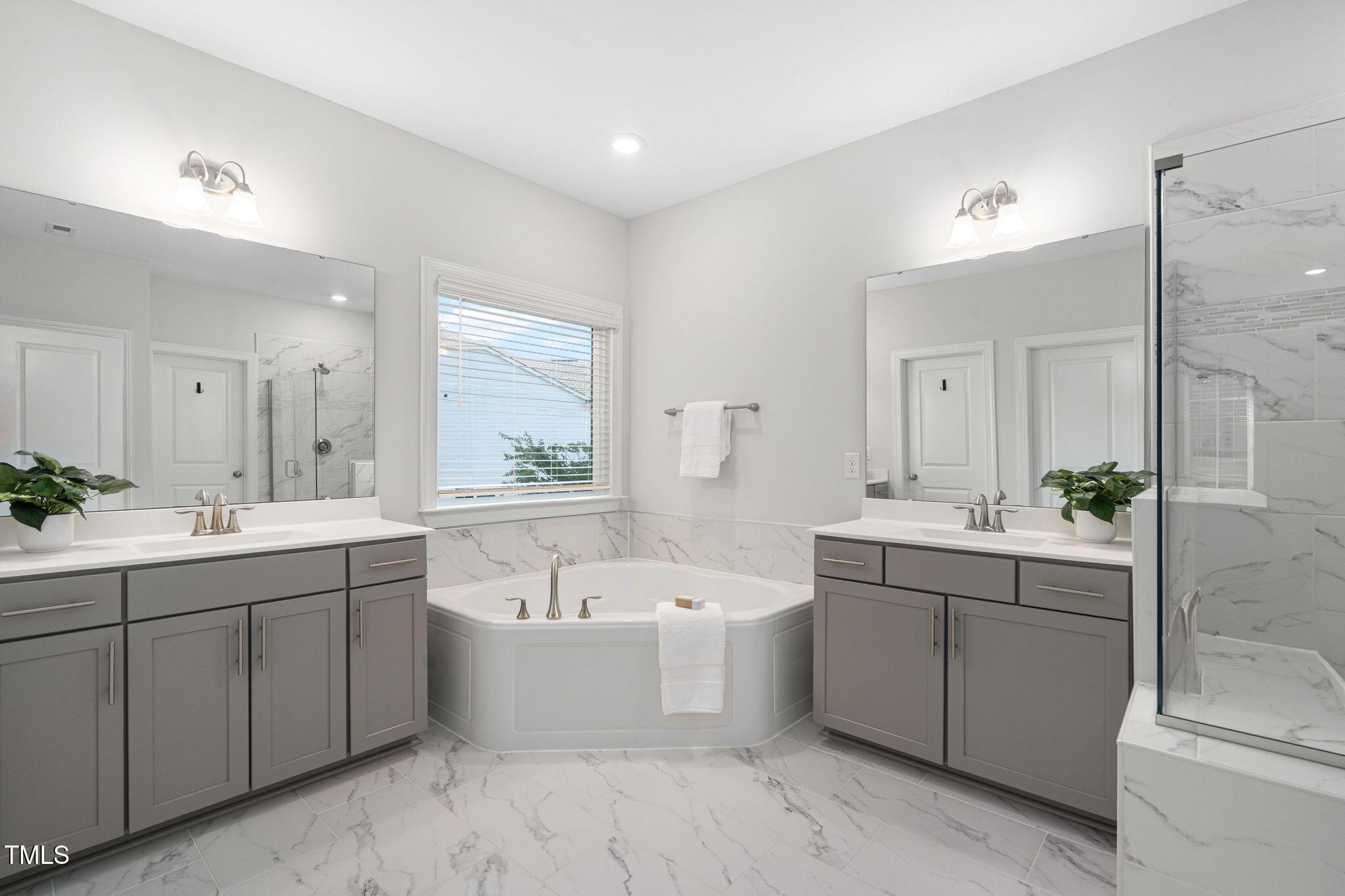 705 Blue Pointe Path Apex, NC 27523 - Photo 25 of 39 a large bathroom with a double vanity sink mirror and bathtub