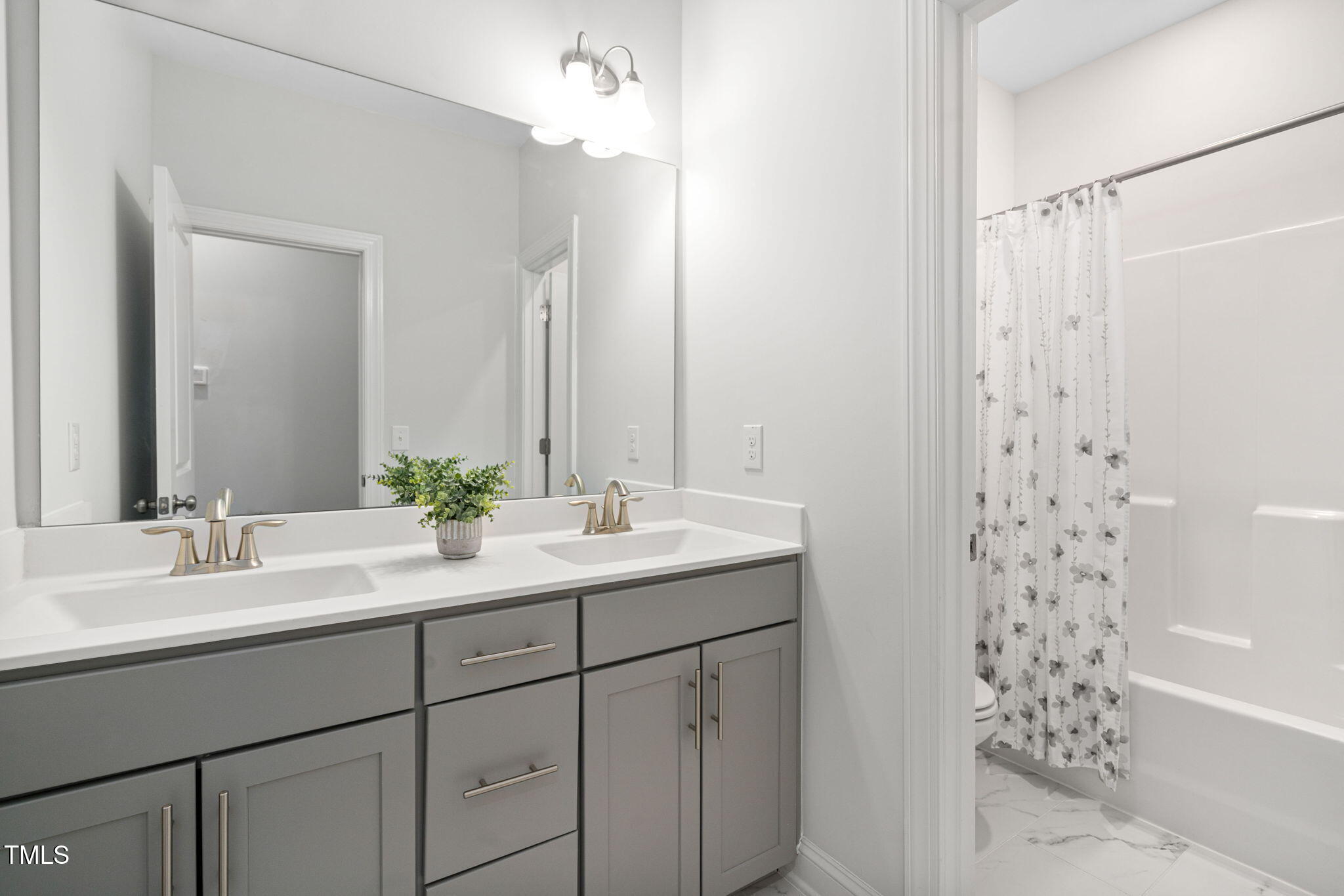 705 Blue Pointe Path Apex, NC 27523 - Photo 29 of 39 a bathroom with a sink double vanity and a mirror