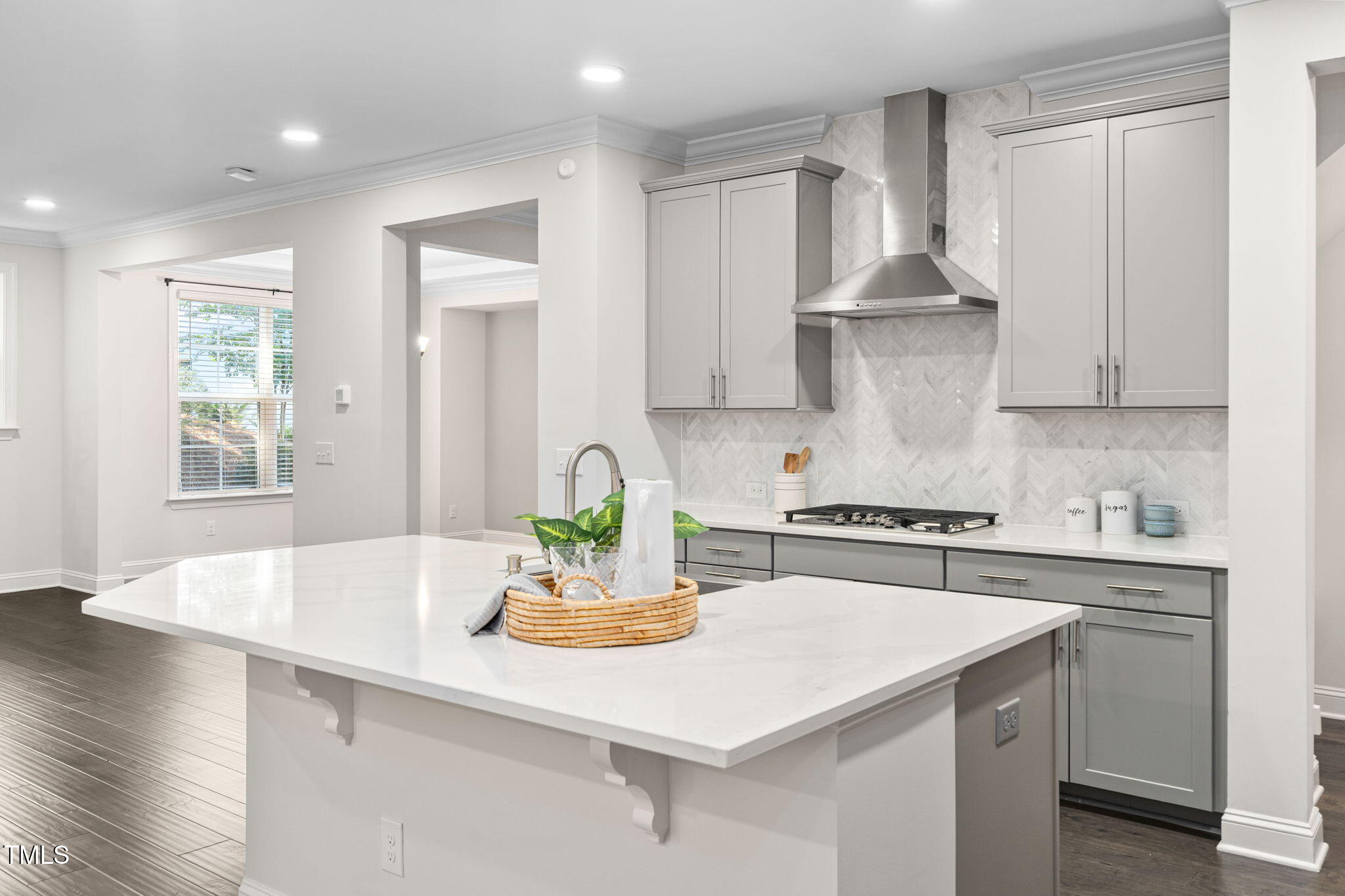 705 Blue Pointe Path Apex, NC 27523 - Photo 8 of 39 a kitchen with stainless steel appliances a sink a stove a refrigerator white cabinets and wooden floor