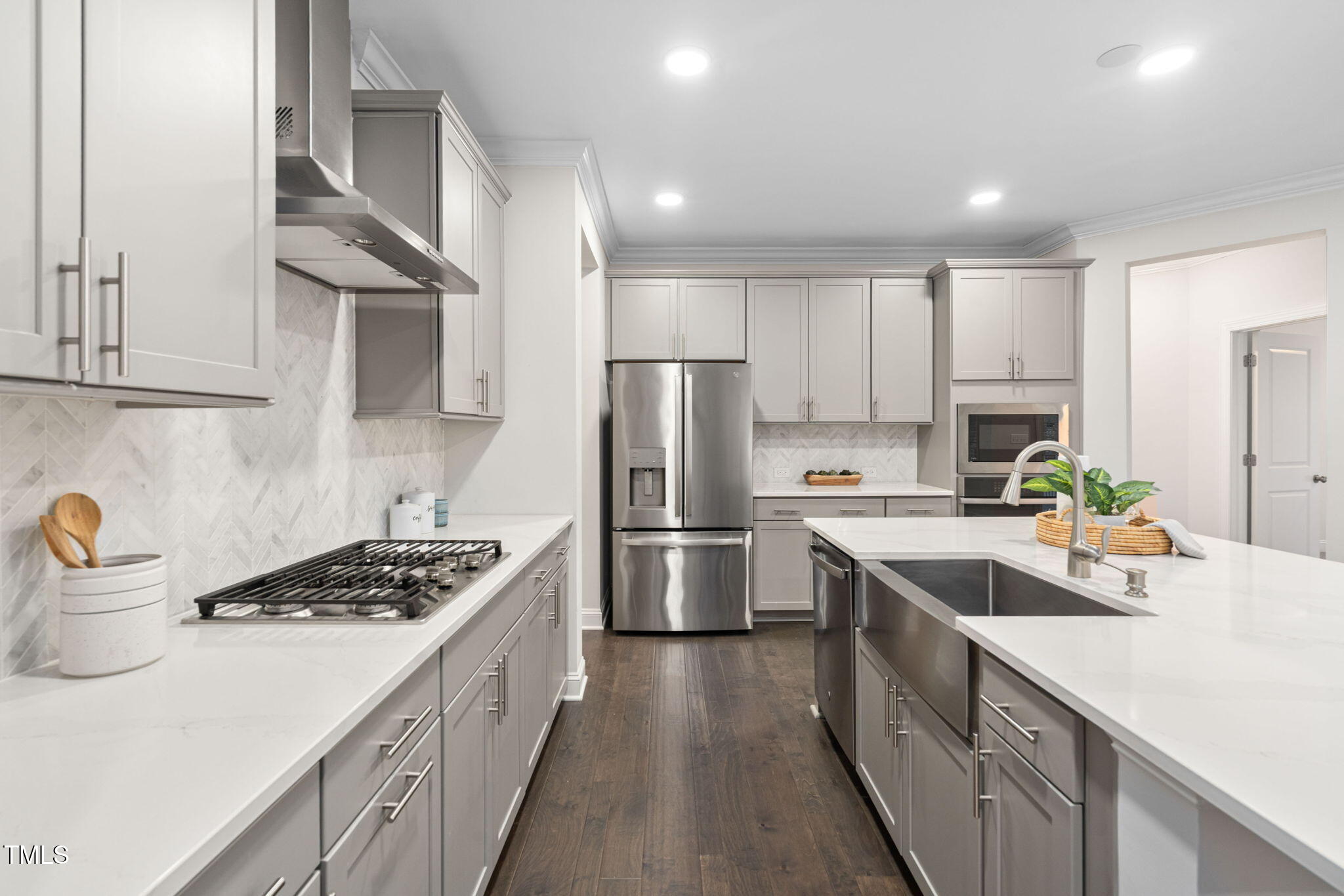 705 Blue Pointe Path Apex, NC 27523 - Photo 9 of 39 a kitchen with kitchen island stainless steel appliances a sink stove and refrigerator