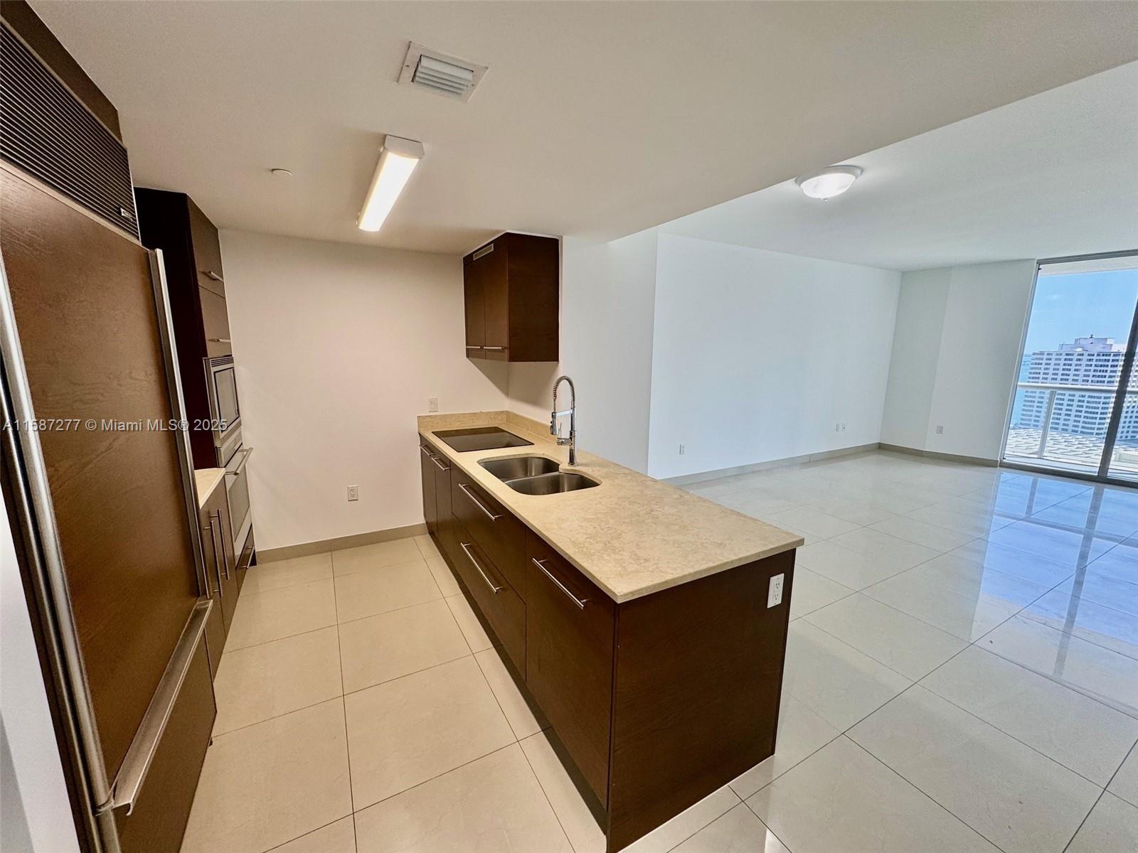 Brickell Miami, FL 33131 - Photo 3 of 15 a kitchen with stainless steel appliances a refrigerator and a stove
